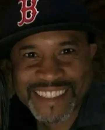 Jean Nicolas smiling in a Boston Red Sox cap
